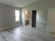 Bedroom showcasing grey walls, wood-style flooring, and a bathroom view at 8640 Portofino Ct, Las Vegas, NV 89117
