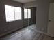 Bedroom with wood-style floors, windows, and closet at 8640 Portofino Ct, Las Vegas, NV 89117