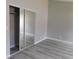 Bedroom featuring closet, grey walls, and wood-style flooring at 8640 Portofino Ct, Las Vegas, NV 89117