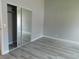 Bedroom with closet, grey walls, and wood-style flooring at 8640 Portofino Ct, Las Vegas, NV 89117