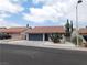 Charming single-story home featuring a tile roof, two-car garage, and low-maintenance desert landscaping at 8640 Portofino Ct, Las Vegas, NV 89117