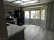 Bright eat-in kitchen boasts stainless steel appliances, quartz countertops, and modern gray cabinetry at 8640 Portofino Ct, Las Vegas, NV 89117