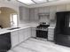Modern kitchen featuring stainless steel appliances, quartz countertops, gray cabinets and eat-in area at 8640 Portofino Ct, Las Vegas, NV 89117