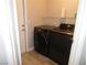 Laundry room featuring modern appliances, a white door and a wire shelf at 8640 Portofino Ct, Las Vegas, NV 89117