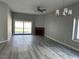 Bright living room featuring a fireplace, sliding glass doors, ceiling fan and modern light fixture at 8640 Portofino Ct, Las Vegas, NV 89117