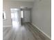 Open-concept living room with new laminate flooring and a view into the kitchen at 8640 Portofino Ct, Las Vegas, NV 89117
