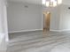 Spacious living room with sleek gray walls, modern light fixture, and wood-look flooring at 8640 Portofino Ct, Las Vegas, NV 89117
