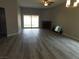 Bright living room features modern flooring, sliding glass doors, and a cozy brick fireplace at 8640 Portofino Ct, Las Vegas, NV 89117