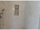Detail of a shower with white marble-style tile and mosaic niche at 8640 Portofino Ct, Las Vegas, NV 89117