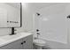 Bright bathroom features shower over tub, modern vanity, and matte black plumbing fixtures at 884 Adobe Flat Dr, Henderson, NV 89011