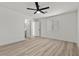 Bedroom featuring ceiling fan, doorway to bathroom and wood-look floors at 884 Adobe Flat Dr, Henderson, NV 89011