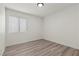 Compact bedroom featuring white walls, window and wood-look floors at 884 Adobe Flat Dr, Henderson, NV 89011