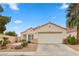 Charming single-story home showcasing a well-manicured front yard and attached two-car garage at 884 Adobe Flat Dr, Henderson, NV 89011