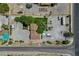 Aerial view of an expansive property with a house, large parking area, swimming pool and mature trees at 8970 W Lone Mountain Rd, Las Vegas, NV 89129