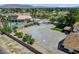 Property featuring lush greenery, a detached garage, and spacious parking area, complemented by desert landscaping at 8970 W Lone Mountain Rd, Las Vegas, NV 89129