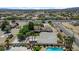 Wide-angle shot showcases lot with a house, mature trees, and palm trees, in a neighborhood setting with mountain views at 8970 W Lone Mountain Rd, Las Vegas, NV 89129