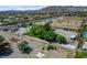 Property featuring mature landscaping, desert surroundings, a container, and garden beds in a residential area at 8970 W Lone Mountain Rd, Las Vegas, NV 89129