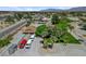Aerial shot of a home featuring multiple containers and vehicle parking, mature palm trees, and desert landscaping at 8970 W Lone Mountain Rd, Las Vegas, NV 89129