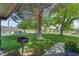 Backyard featuring mature trees, lawn, and a grill perfect for outdoor enjoyment and entertaining at 8970 W Lone Mountain Rd, Las Vegas, NV 89129