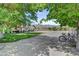 Large backyard with a gravel area, lawn, mature trees, and outdoor dining space, perfect for outdoor living at 8970 W Lone Mountain Rd, Las Vegas, NV 89129