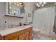 The bathroom has tile floors, a vanity and a shower/tub combo with white curtain at 8970 W Lone Mountain Rd, Las Vegas, NV 89129