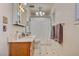 Bright bathroom featuring tiled floors, a vanity and a shower/tub combo with white curtain at 8970 W Lone Mountain Rd, Las Vegas, NV 89129