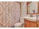 This bathroom offers a toilet, sink, mirror and decorative shower curtain at 8970 W Lone Mountain Rd, Las Vegas, NV 89129