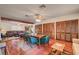 A view of the dining room with hardwood floors and a wooden dining table set with green leather chairs at 8970 W Lone Mountain Rd, Las Vegas, NV 89129