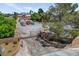 A gated entrance and tree lined drive lend privacy to this home with ample parking at 8970 W Lone Mountain Rd, Las Vegas, NV 89129