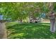 Spacious front yard with mature trees offering shade and curb appeal to this well-maintained home at 8970 W Lone Mountain Rd, Las Vegas, NV 89129
