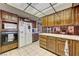 Kitchen featuring tile countertops and backsplash, and wood cabinets and breakfast bar at 8970 W Lone Mountain Rd, Las Vegas, NV 89129