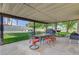Covered patio featuring an outdoor dining area, ideal for entertaining and enjoying the backyard at 8970 W Lone Mountain Rd, Las Vegas, NV 89129