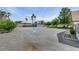Wide shot of a property featuring gravel, lawn, mature trees, and a covered patio on the side of the house at 8970 W Lone Mountain Rd, Las Vegas, NV 89129