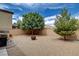 Backyard featuring gravel landscaping, trees, and a fire pit at 900 Harbor Ave, Henderson, NV 89002