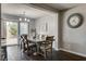 A lovely dining area featuring wood floors, a chandelier, and sliding glass doors to the backyard at 900 Harbor Ave, Henderson, NV 89002