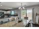 Dining area with wood floors, stylish light fixture, and views of the kitchen and backyard at 900 Harbor Ave, Henderson, NV 89002