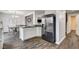 Modern kitchen with breakfast bar, stainless steel refrigerator and views of the dining area at 900 Harbor Ave, Henderson, NV 89002