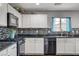 Modern kitchen with stainless steel appliances, white cabinets, and stylish backsplash at 900 Harbor Ave, Henderson, NV 89002