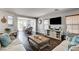 Inviting living room featuring stylish wood floors, neutral paint, comfortable seating, and an open floor plan at 900 Harbor Ave, Henderson, NV 89002