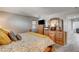 Spacious main bedroom with dresser, TV, and decorative mirror at 900 Harbor Ave, Henderson, NV 89002