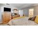 This main bedroom includes a television, dresser, and ensuite bathroom at 900 Harbor Ave, Henderson, NV 89002