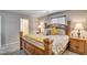 A spacious main bedroom features a wooden bed frame and matching nightstands and lamps at 900 Harbor Ave, Henderson, NV 89002