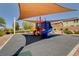Colorful community playground with shade, featuring a slide and climbing structure at 900 Harbor Ave, Henderson, NV 89002