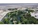 Aerial view reveals a pond surrounded by lush trees, greenery, and a walking path, creating a nature-filled environment at 9052 Pine Mission Ave, Las Vegas, NV 89143