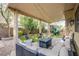 Backyard with a covered patio, seating, a playset with a slide, and some trees at 9052 Pine Mission Ave, Las Vegas, NV 89143