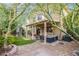 The backyard has a covered patio with backyard seating, a playset, and mature trees for shade at 9052 Pine Mission Ave, Las Vegas, NV 89143