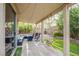 The covered patio leads to green areas with a built in seating area and mature shade trees at 9052 Pine Mission Ave, Las Vegas, NV 89143