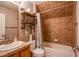 Charming bathroom featuring a tiled shower-tub combination and rustic open shelving at 9052 Pine Mission Ave, Las Vegas, NV 89143