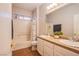 This bathroom features double sinks with tile counter tops and a shower and tub combination at 9052 Pine Mission Ave, Las Vegas, NV 89143