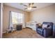 This bedroom is cozy with carpet, neutral walls, a ceiling fan, and window for lots of natural light at 9052 Pine Mission Ave, Las Vegas, NV 89143
